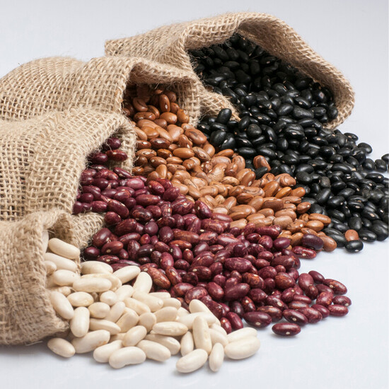 Assorted beans in a burlap sack showcasing vibrant colors and textures for healthy cooking.